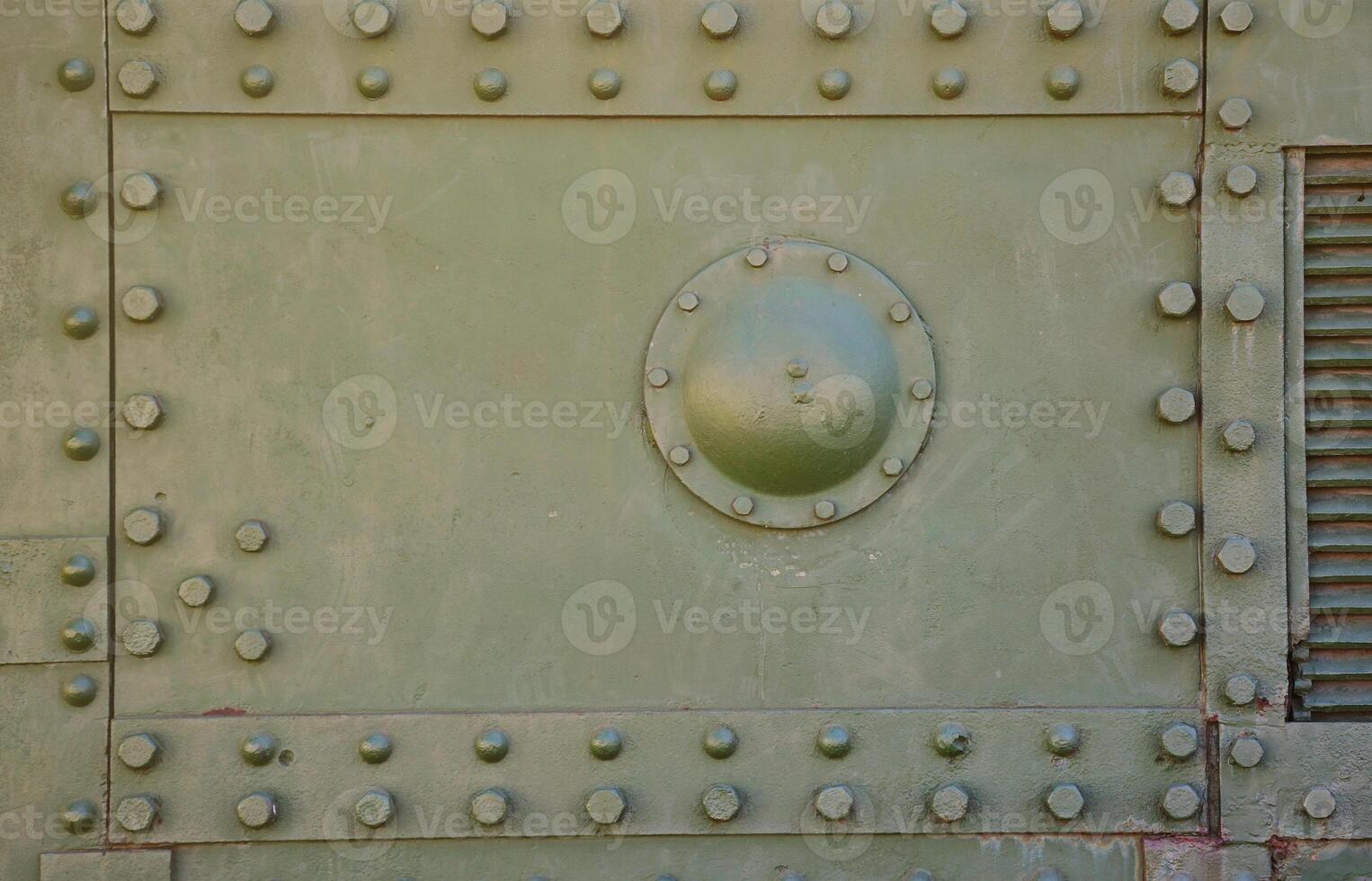 The texture of the wall of the tank, made of metal and reinforced with a multitude of bolts and rivets. Images of the covering of a combat vehicle from the Second World War photo