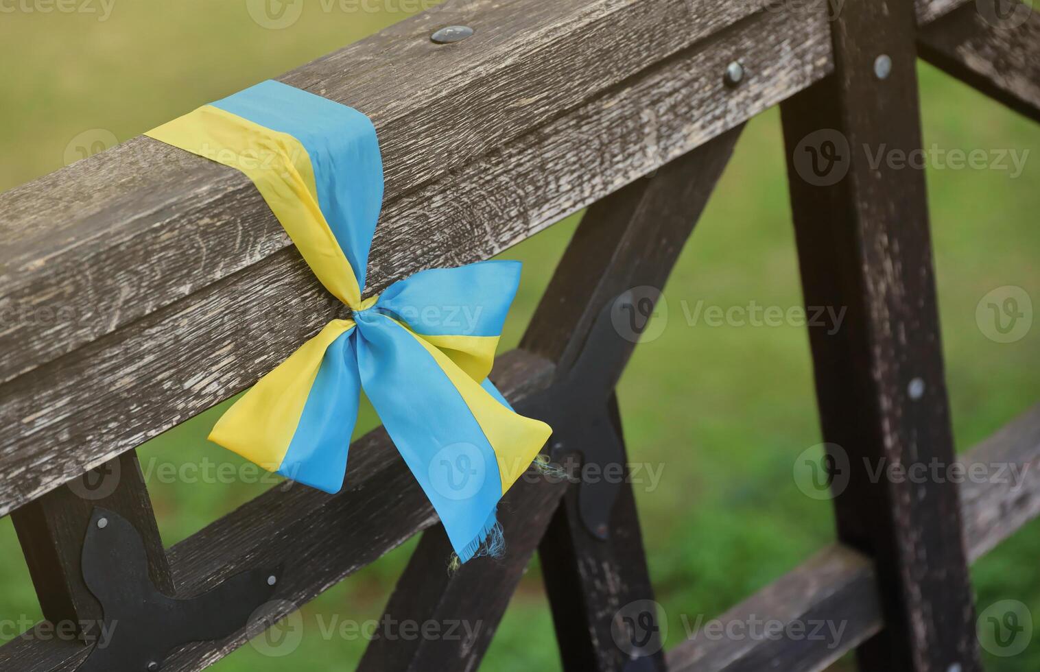 Ribbons in the colors of the national flag of Ukraine are tied to the handrail photo