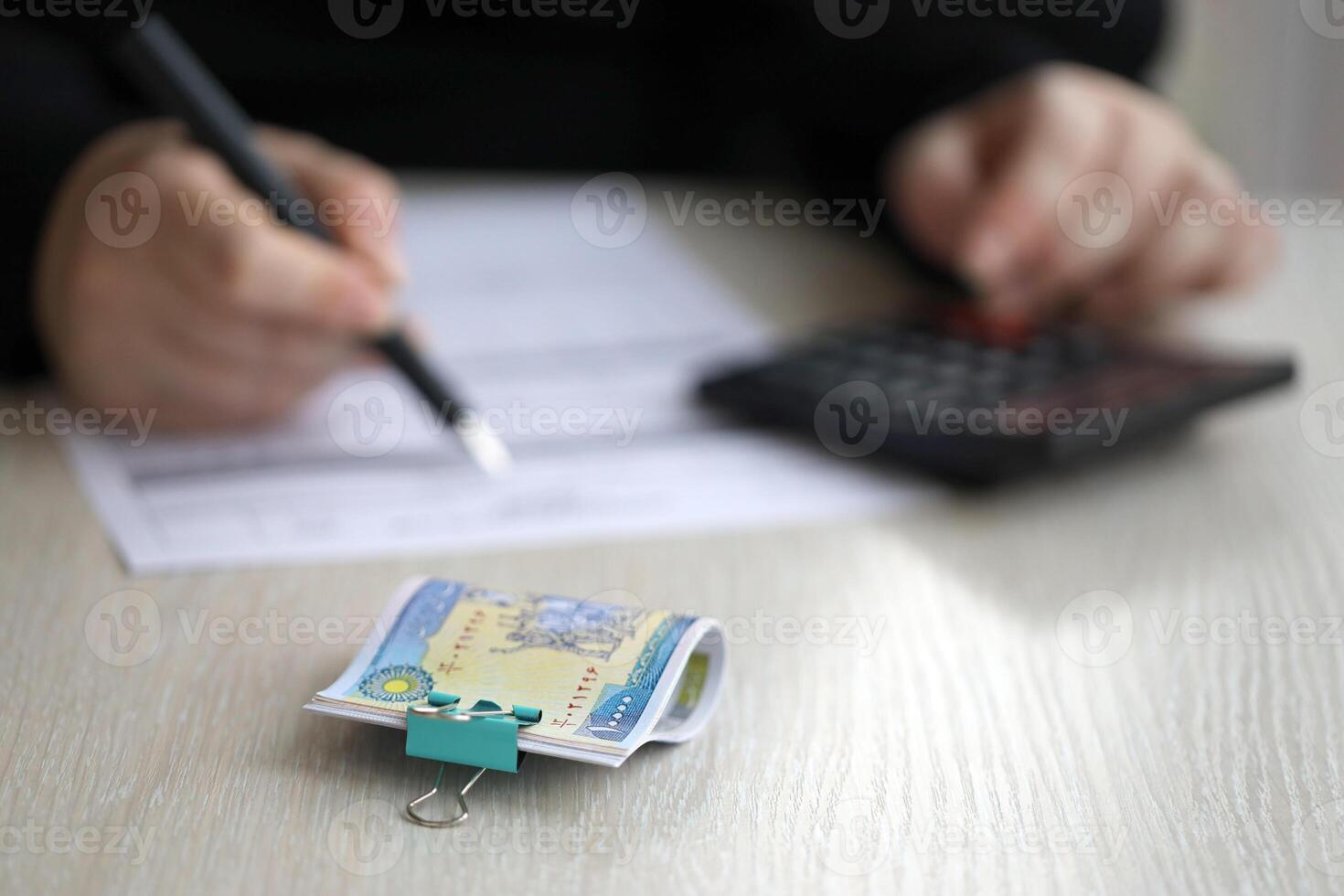 Accountant start to fill Iranian tax form on office table. Taxation period and annual taxpayers routine photo