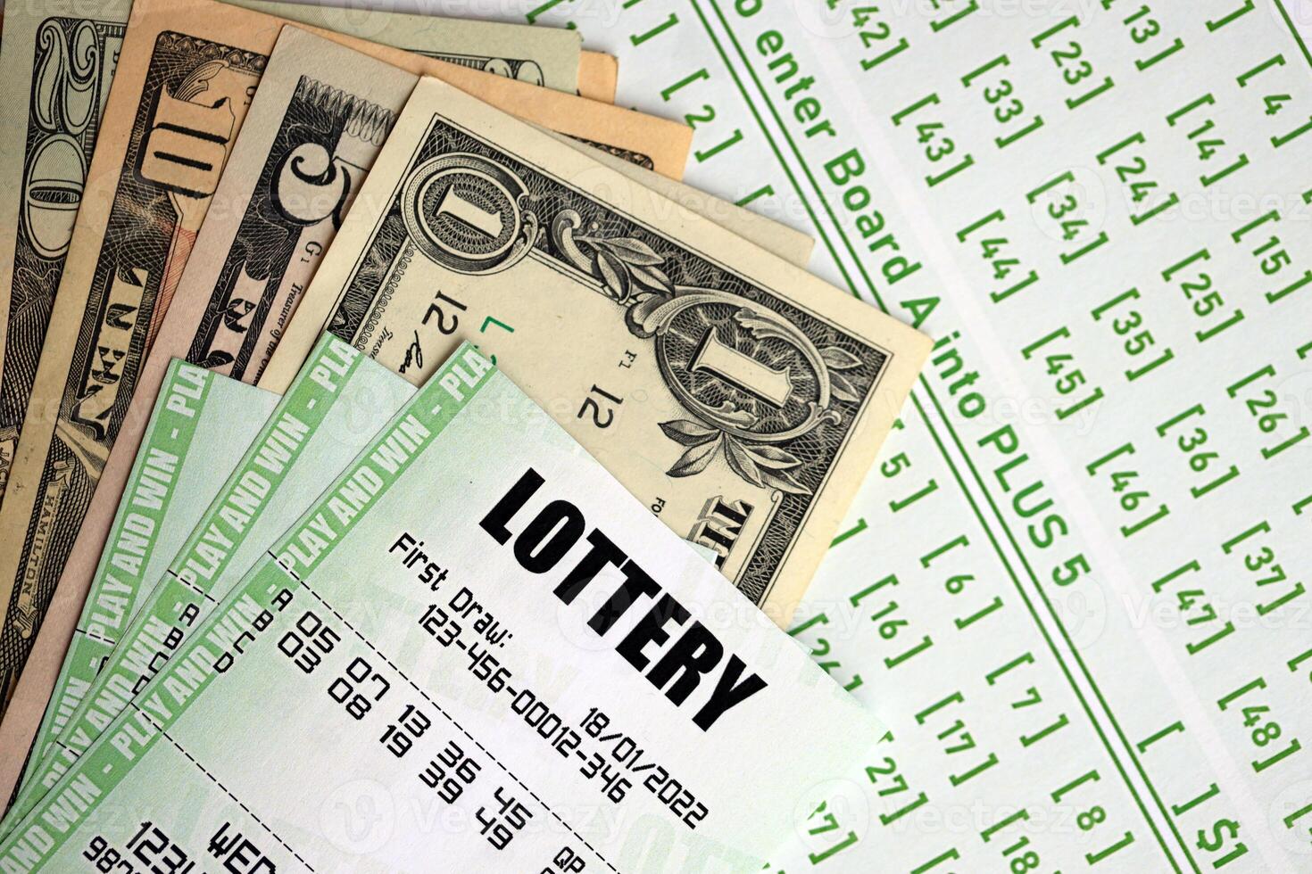 Green lottery tickets and US money bills on blank with numbers for playing lottery photo
