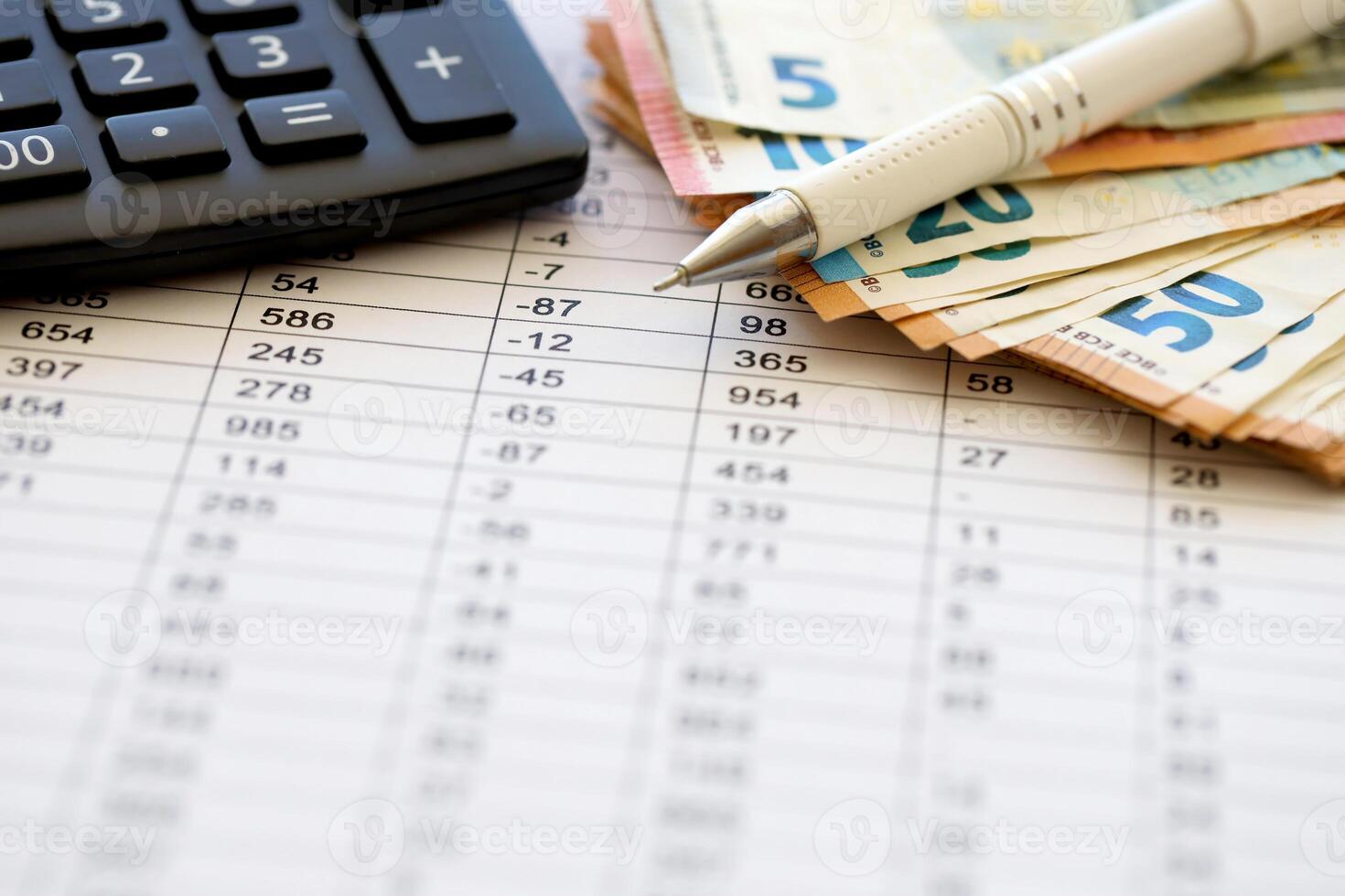 Business concept with many euro money bills, calculator and pen photo
