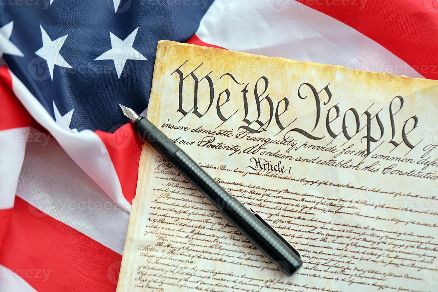 Preamble to the Constitution of the United States and American Flag close up photo