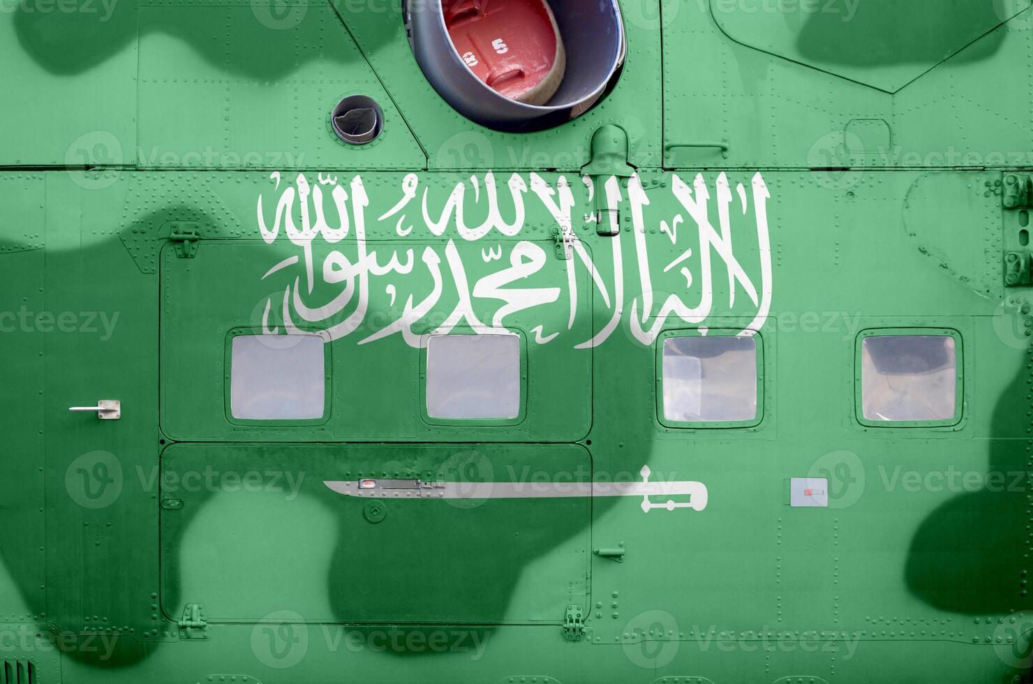 Saudi Arabia flag depicted on side part of military armored helicopter closeup. Army forces aircraft conceptual background photo