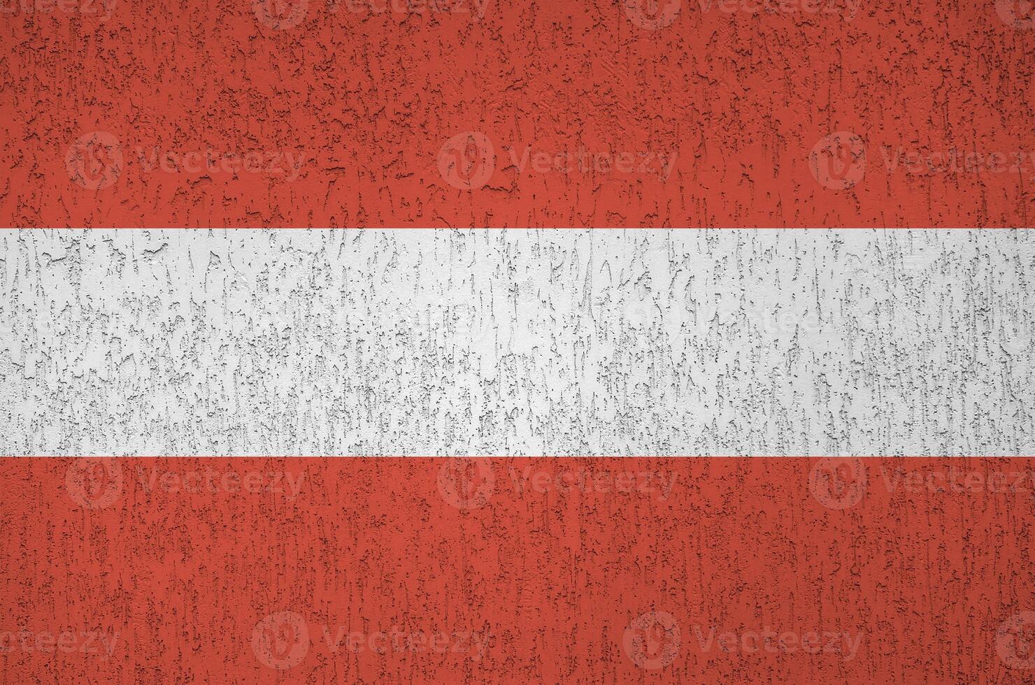 Austria flag depicted in bright paint colors on old relief plastering wall. Textured banner on rough background photo