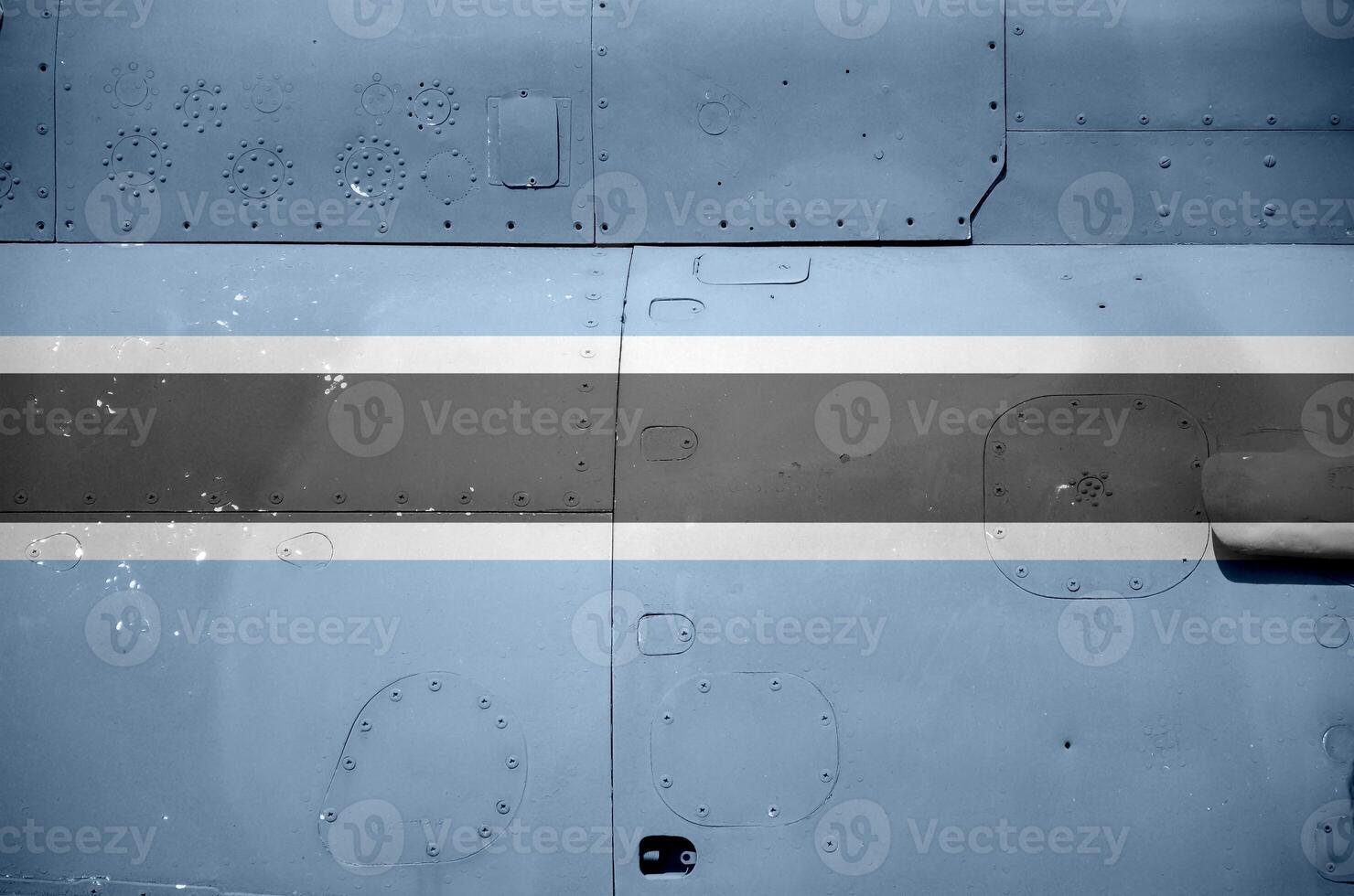 Botswana flag depicted on side part of military armored helicopter closeup. Army forces aircraft conceptual background photo