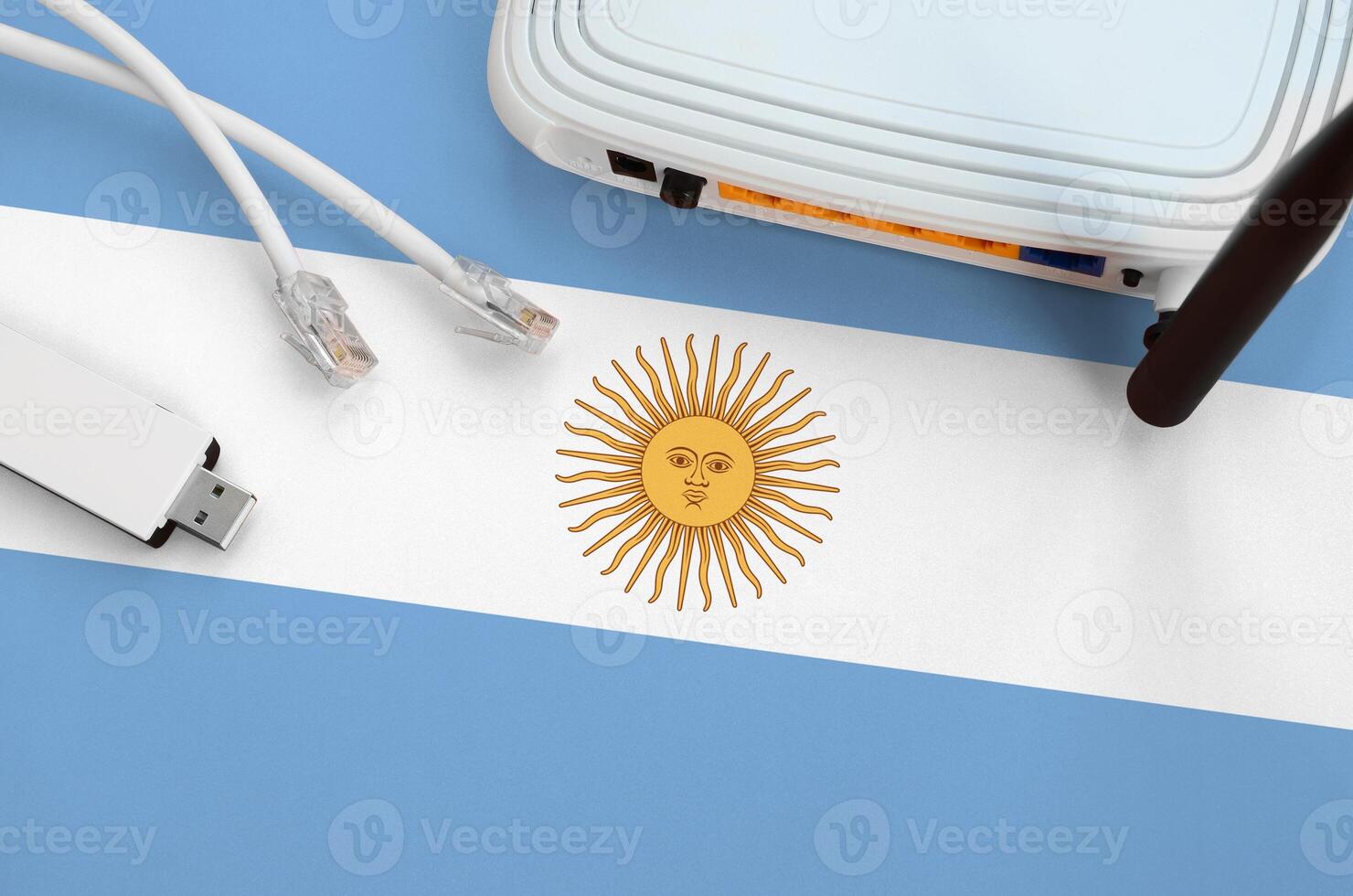 Argentina flag depicted on table with internet rj45 cable, wireless usb wifi adapter and router. Internet connection concept photo