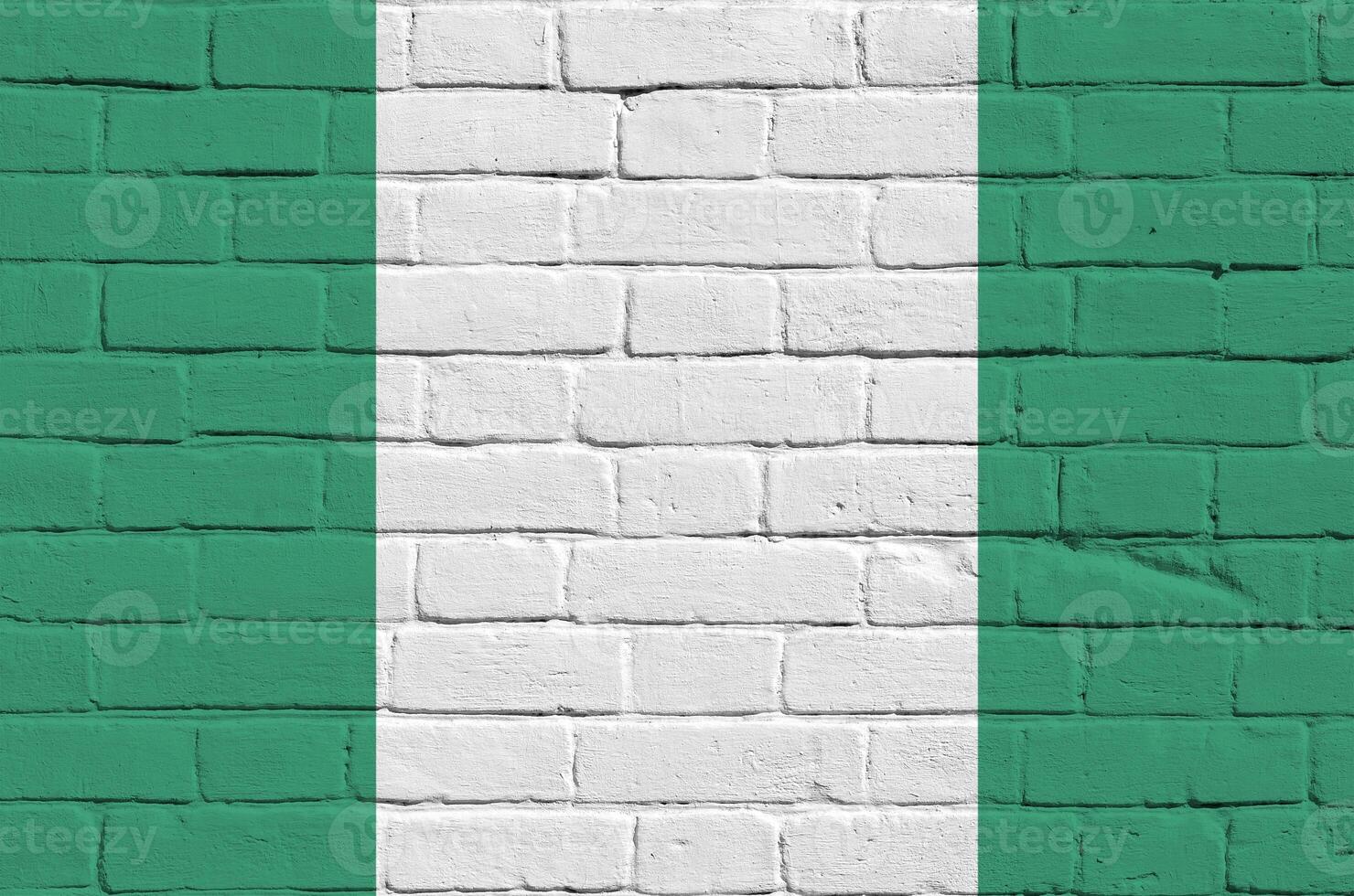 Nigeria flag depicted in paint colors on old brick wall. Textured banner on big brick wall masonry background photo