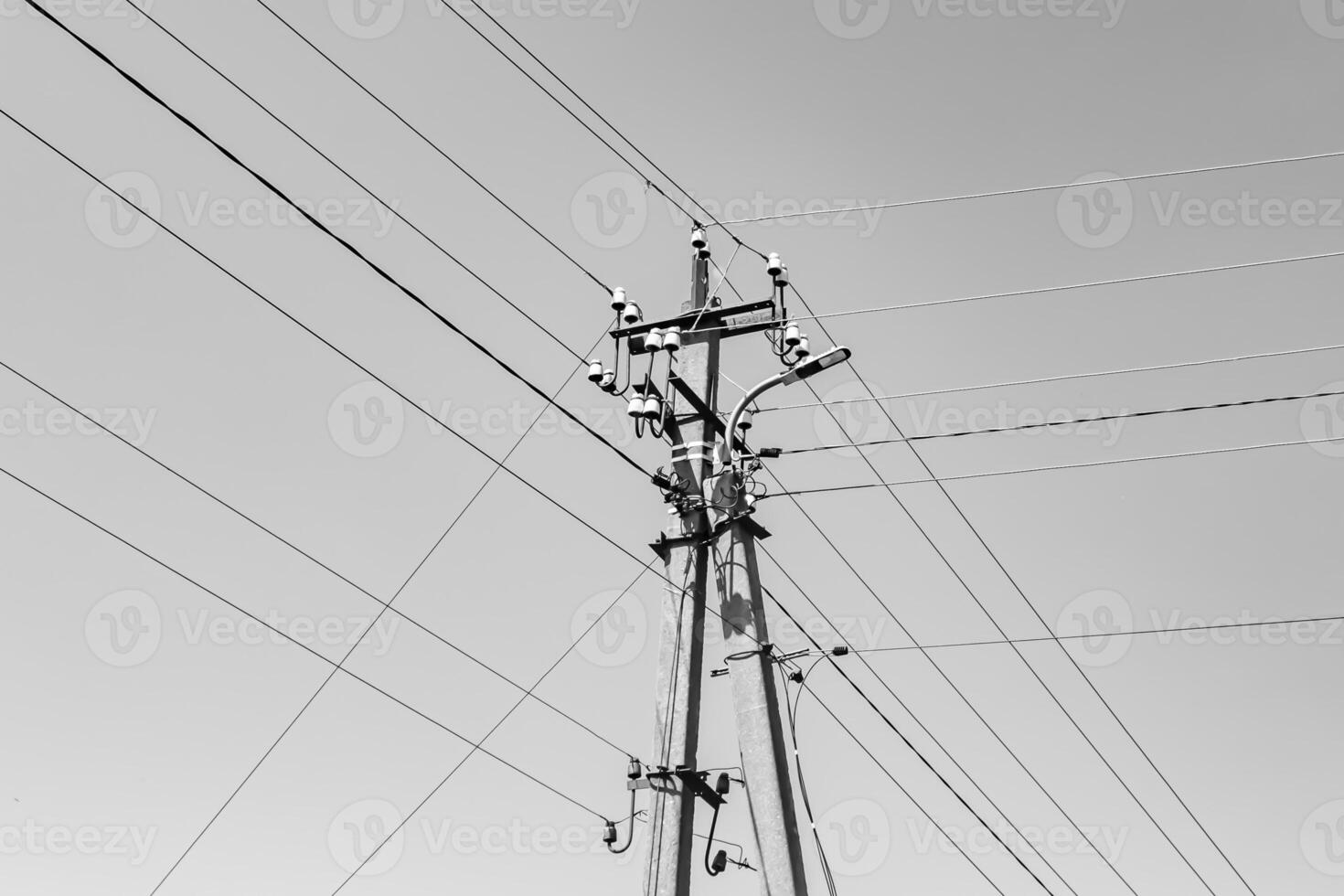 Power electric pole with line wire on light background close up photo