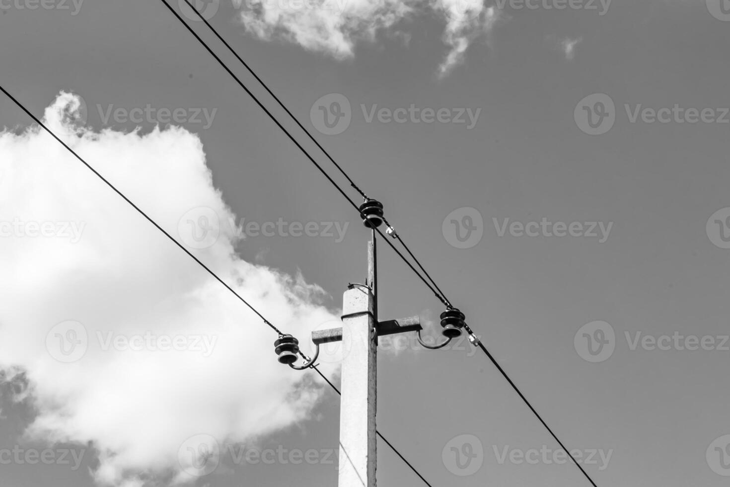 Power electric pole with line wire on light background close up photo