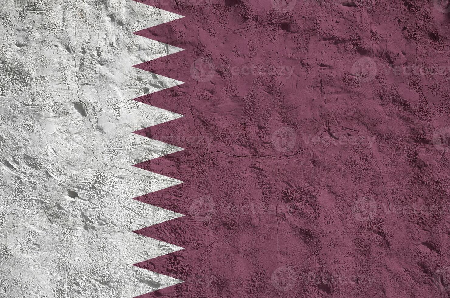Qatar flag depicted in bright paint colors on old relief plastering wall. Textured banner on rough background photo