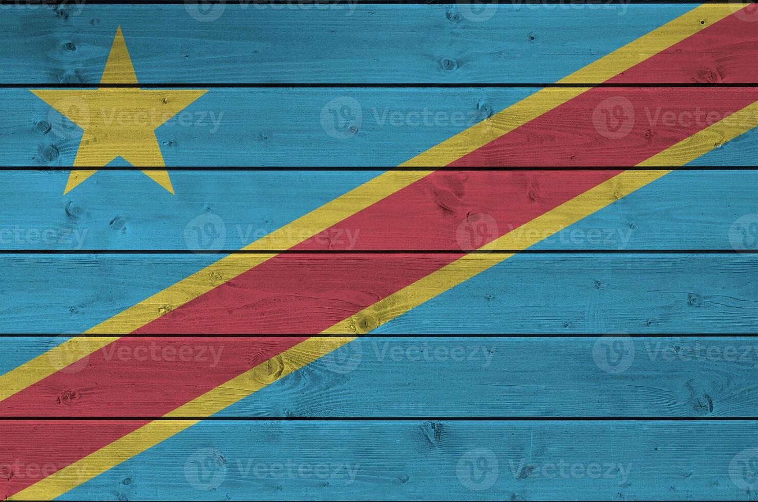 Democratic Republic of the Congo flag depicted in bright paint colors on old wooden wall. Textured banner on rough background photo