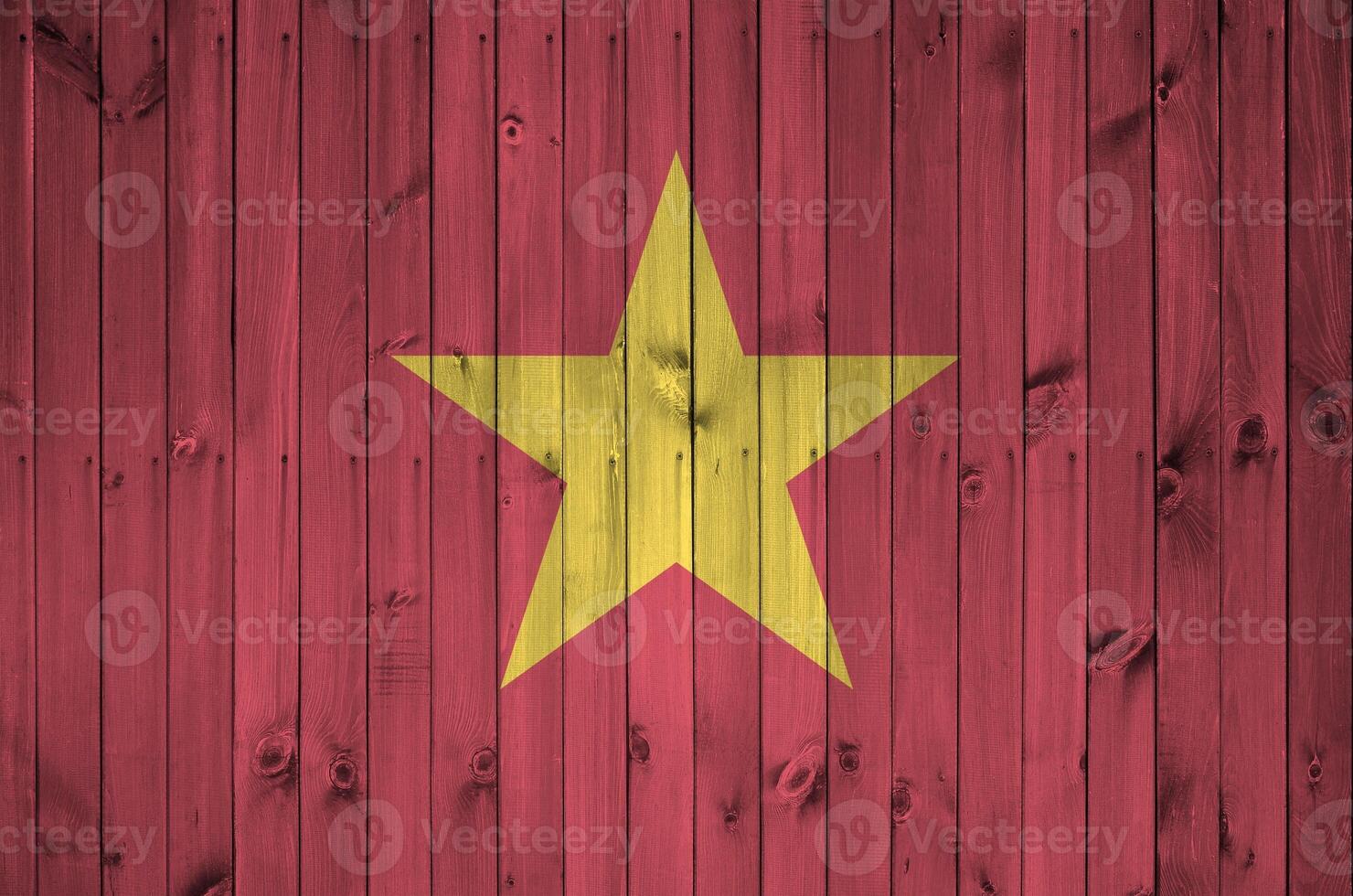 Vietnam flag depicted in bright paint colors on old wooden wall. Textured banner on rough background photo