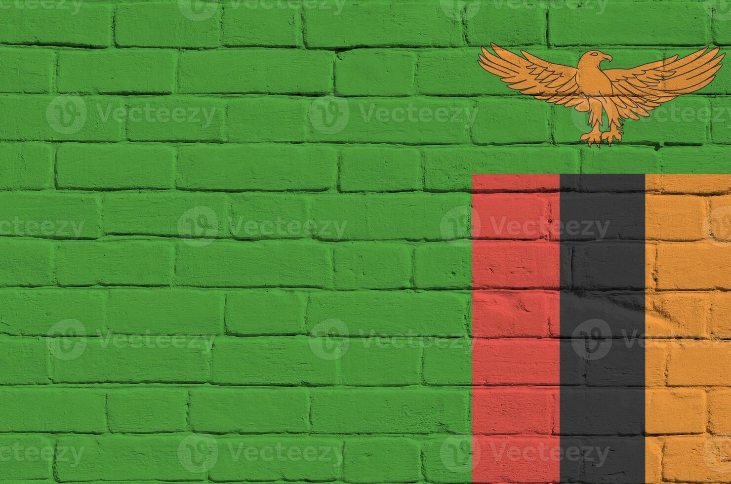 Zambia flag depicted in paint colors on old brick wall. Textured banner on big brick wall masonry background photo