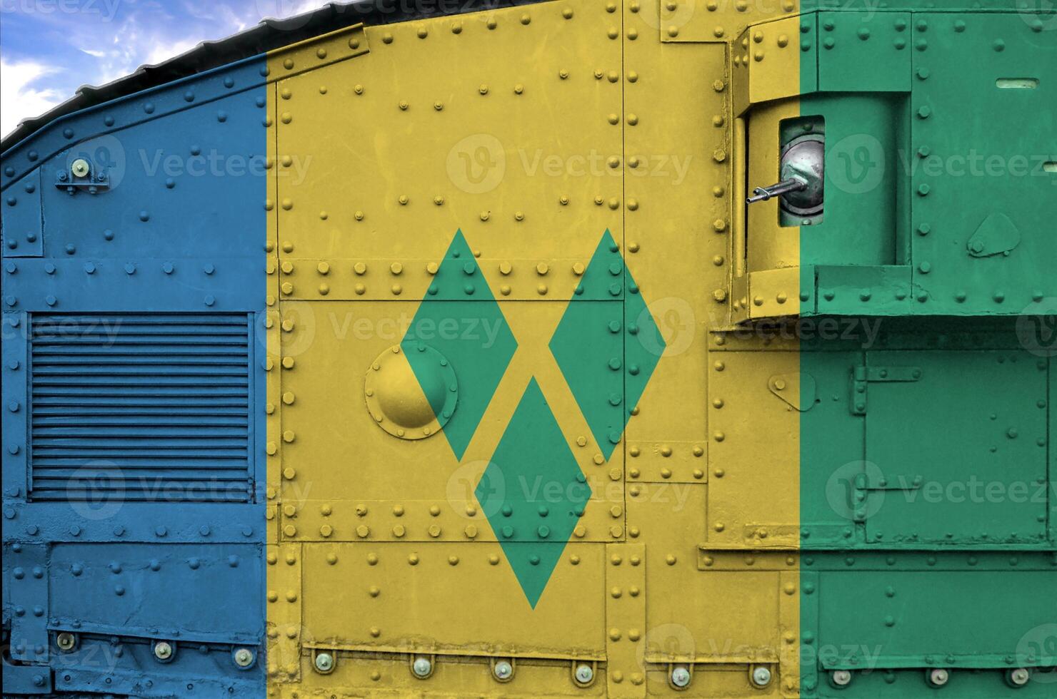 Saint Vincent and the Grenadines flag depicted on side part of military armored tank closeup. Army forces conceptual background photo