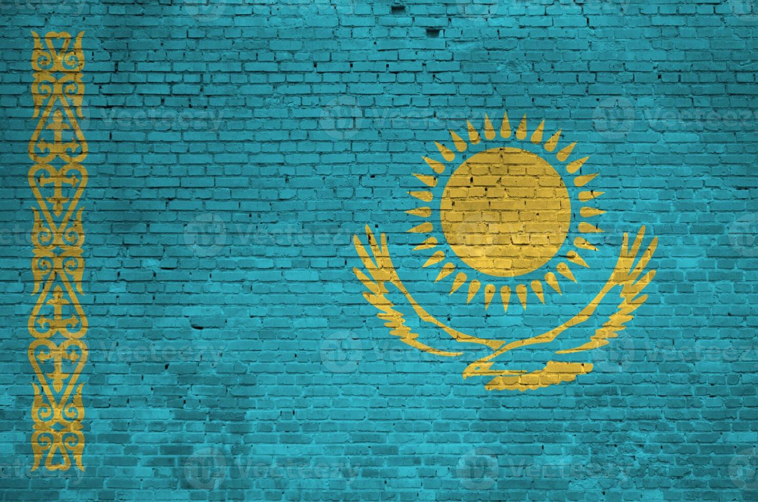 Kazakhstan flag depicted in paint colors on old brick wall. Textured banner on big brick wall masonry background photo