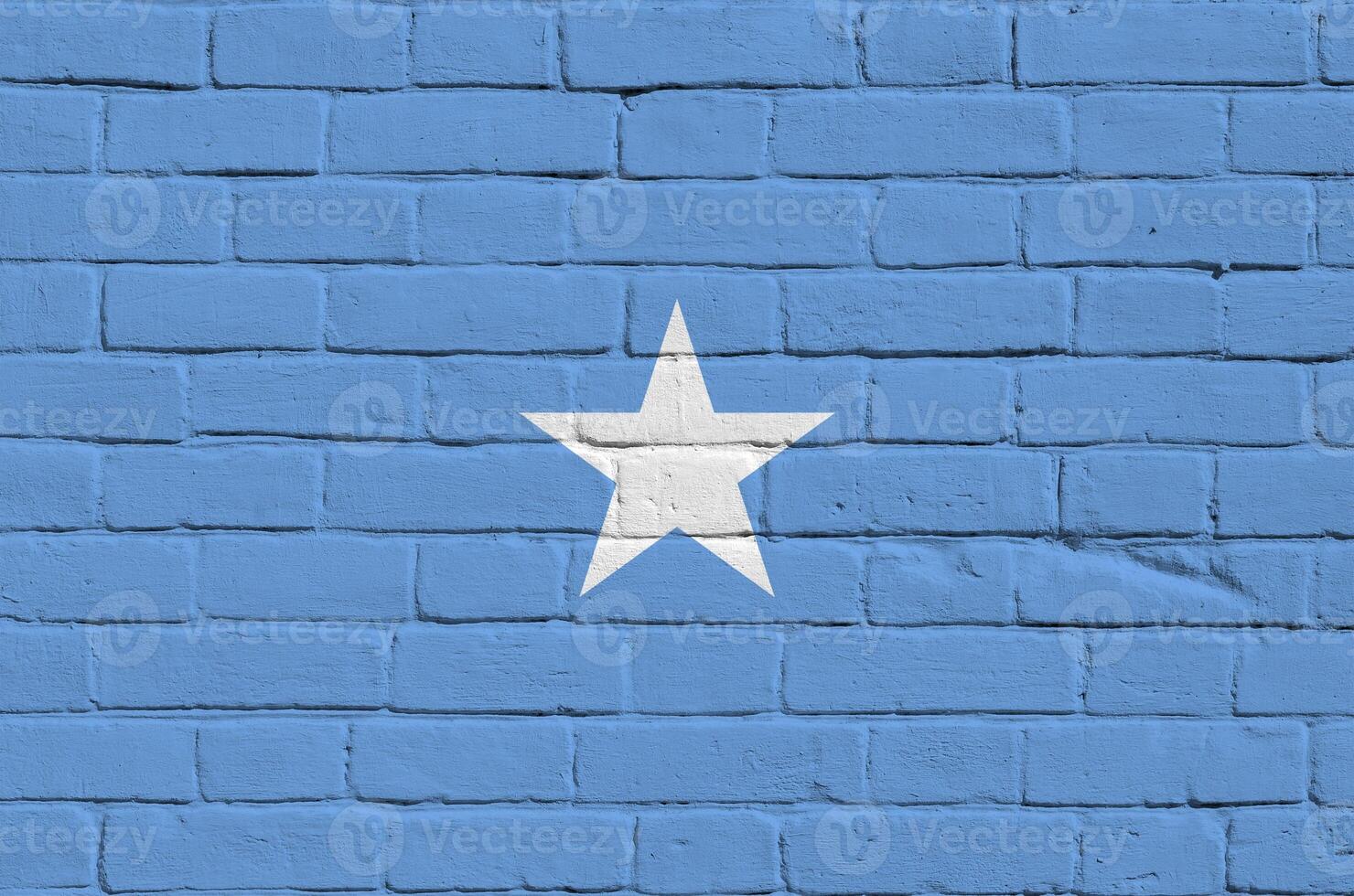 Somalia flag depicted in paint colors on old brick wall. Textured banner on big brick wall masonry background photo