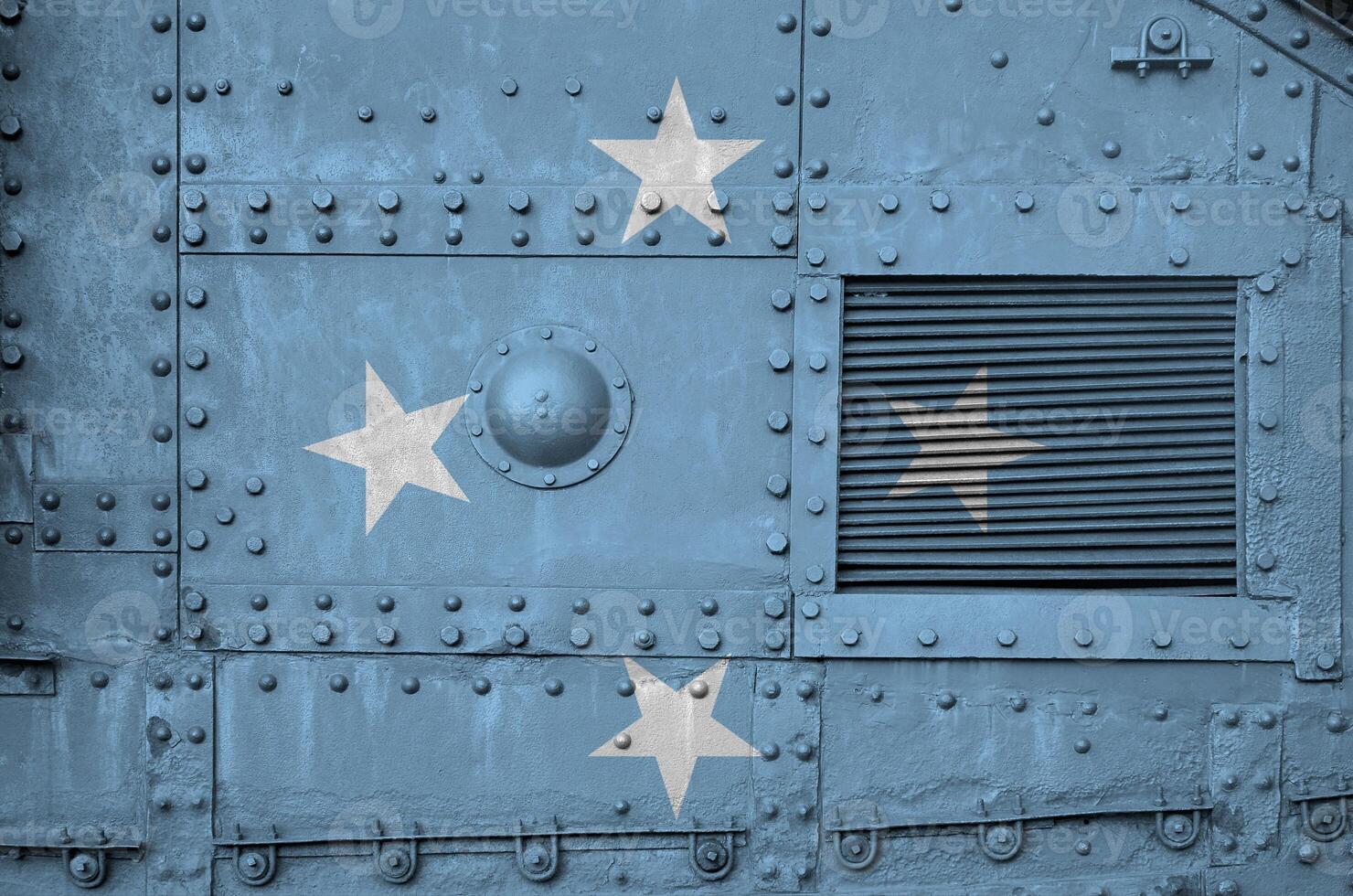 Micronesia flag depicted on side part of military armored tank closeup. Army forces conceptual background photo