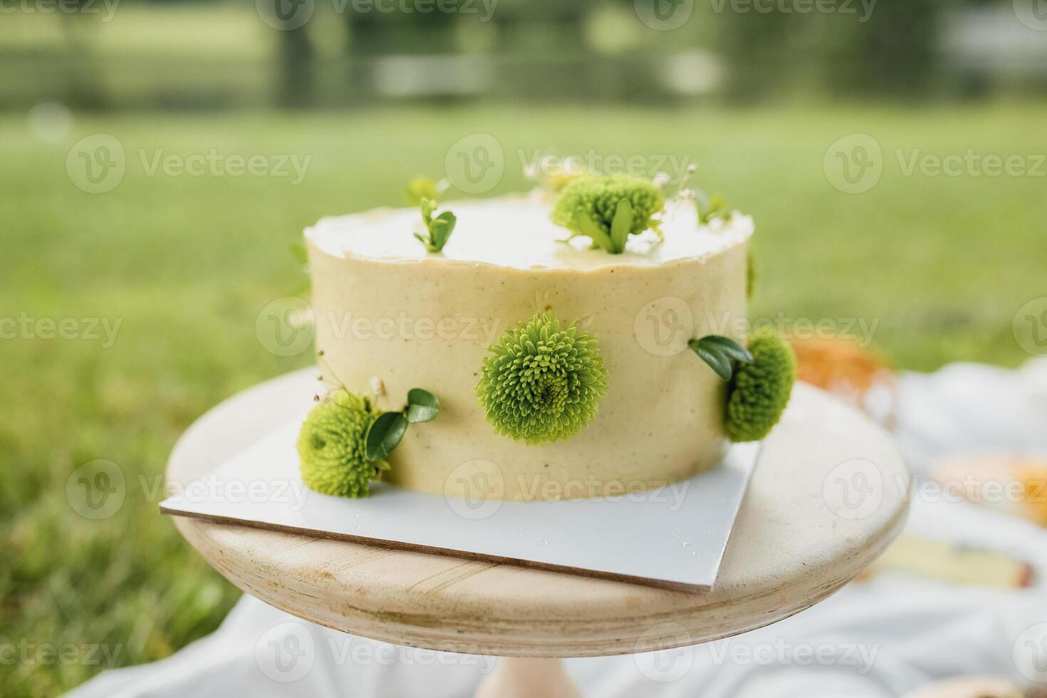 Sunshine Blossom Cake,A luscious yellow cake adorned with vibrant green flowers on top photo