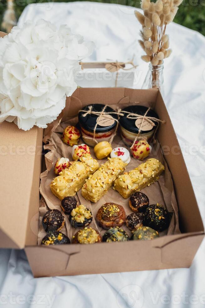 Sweet Blooms. A Box of Pastries and Flowers photo
