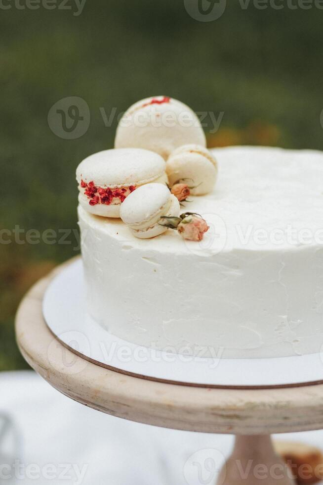 Elegant White Cake Adorned With Colorful Macaroons photo