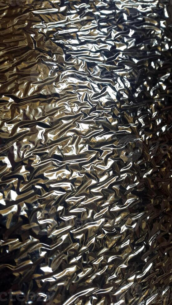 Wrinkled foil surface. Foil texture. Background with crumpled foil photo