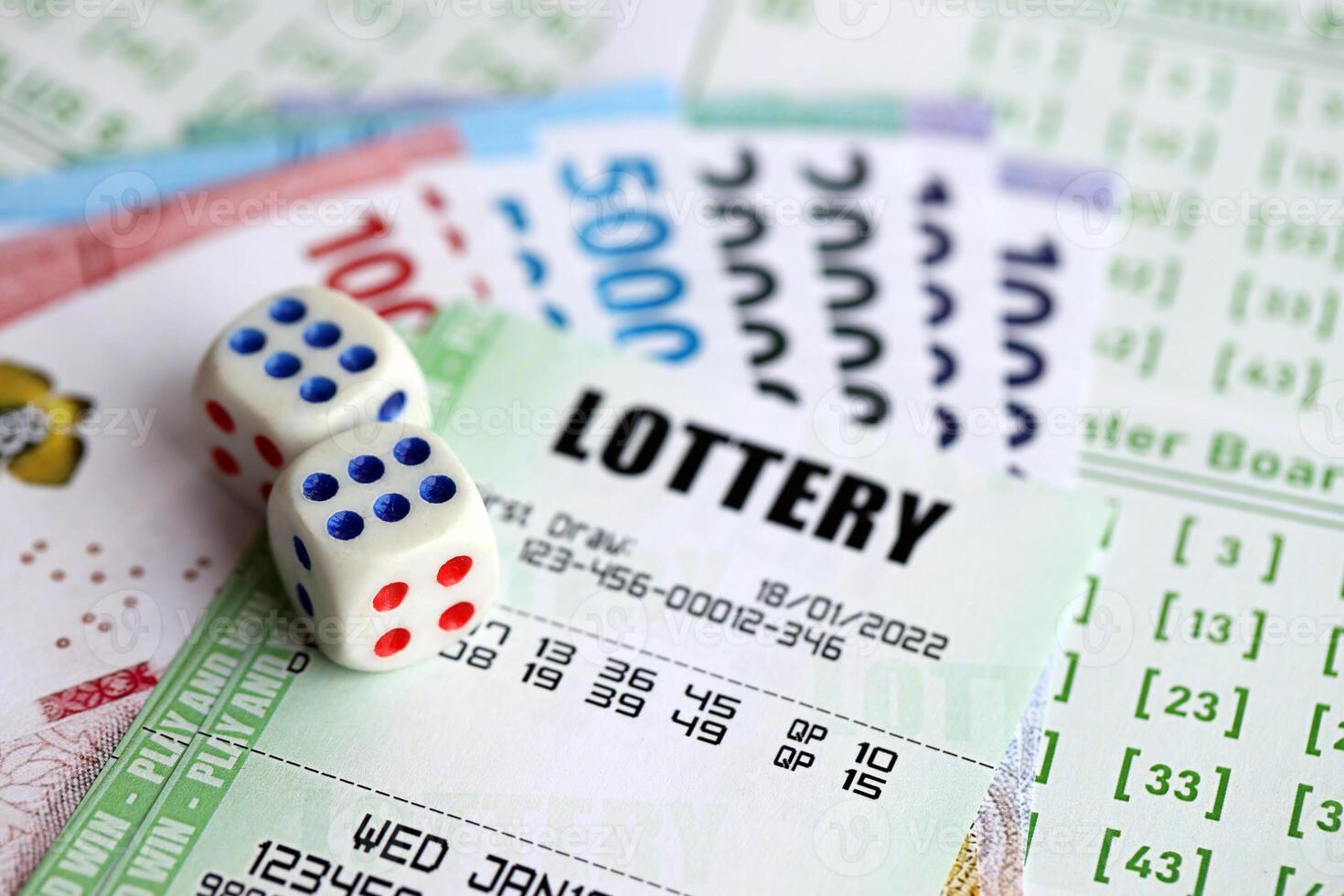 Green lottery tickets and indonesian money bills on blank with numbers for playing lottery photo