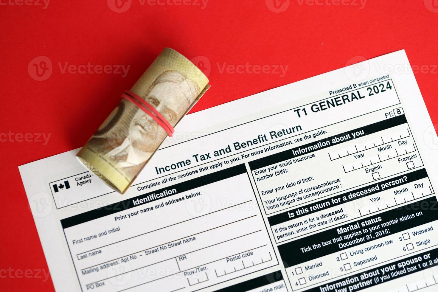 Canadian T1 General tax form Income tax and benefit return lies on table with canadian money bills photo