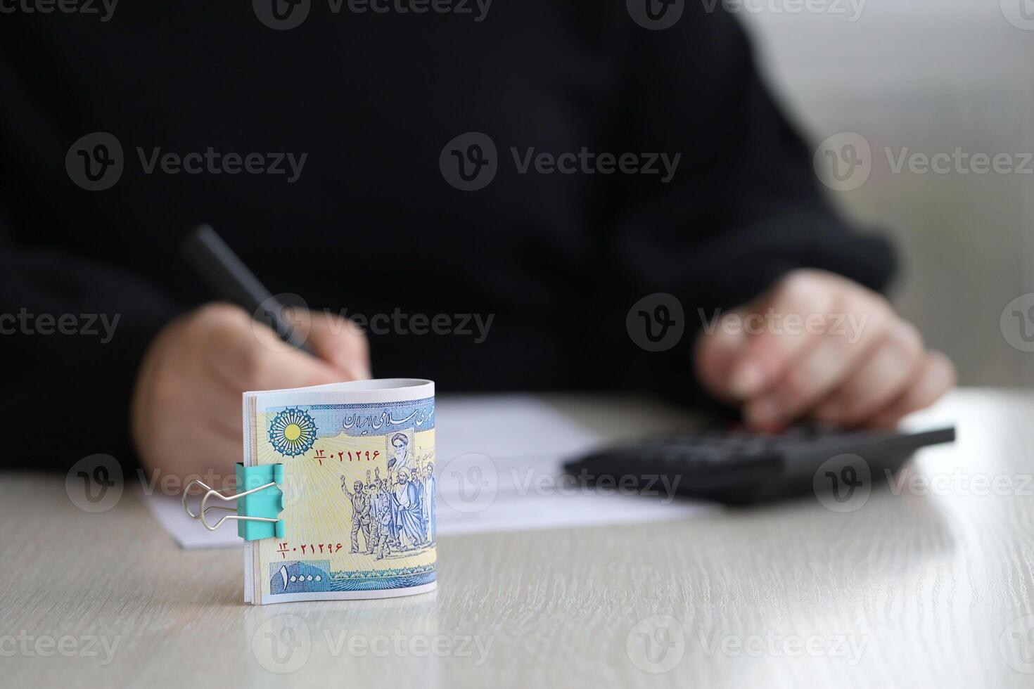 Accountant start to fill Iranian tax form on office table. Taxation period and annual taxpayers routine photo