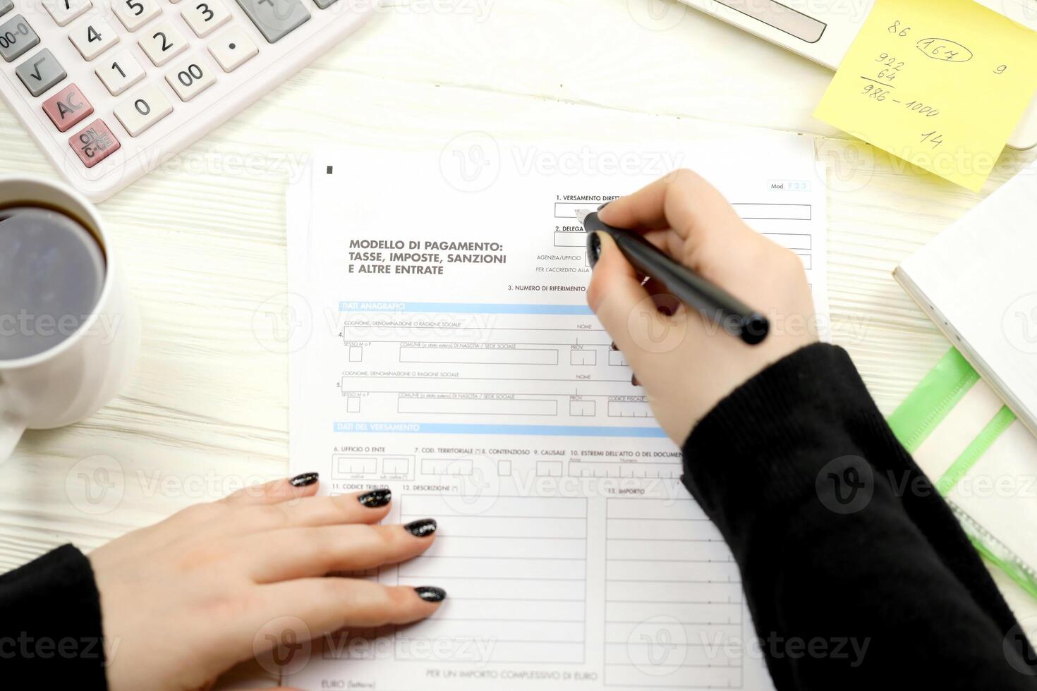 Accountant fill italian tax form F23 Payment model taxes duties penalties and other revenues in end of tax period. Taxation and paperwork routine photo