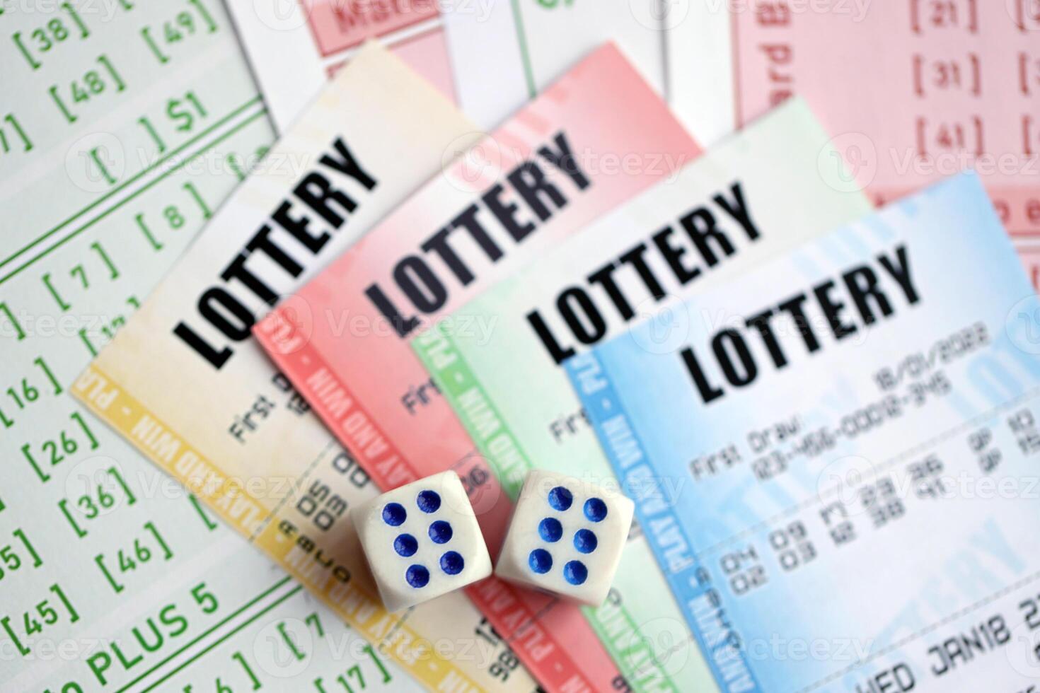 Lottery tickets of different colors and dice on blank bills with numbers for playing lottery photo