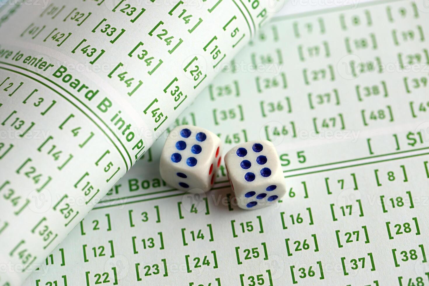 Lottery tickets and dice on blank bills with numbers for playing lottery photo