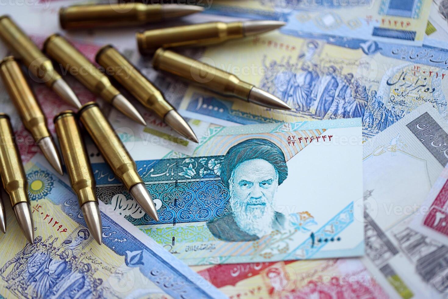 Many bullets and iranian rials money bills close up. Concept of terrorism funding or financial operations to support war photo