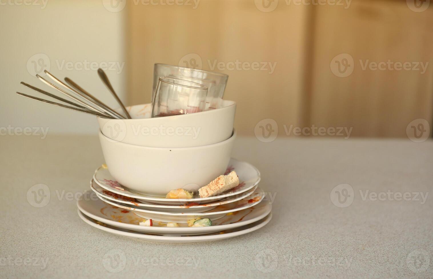 Stack of dirty dishes with food leftovers on the table after meal. Banquet ending concept. Unwashed dishes photo