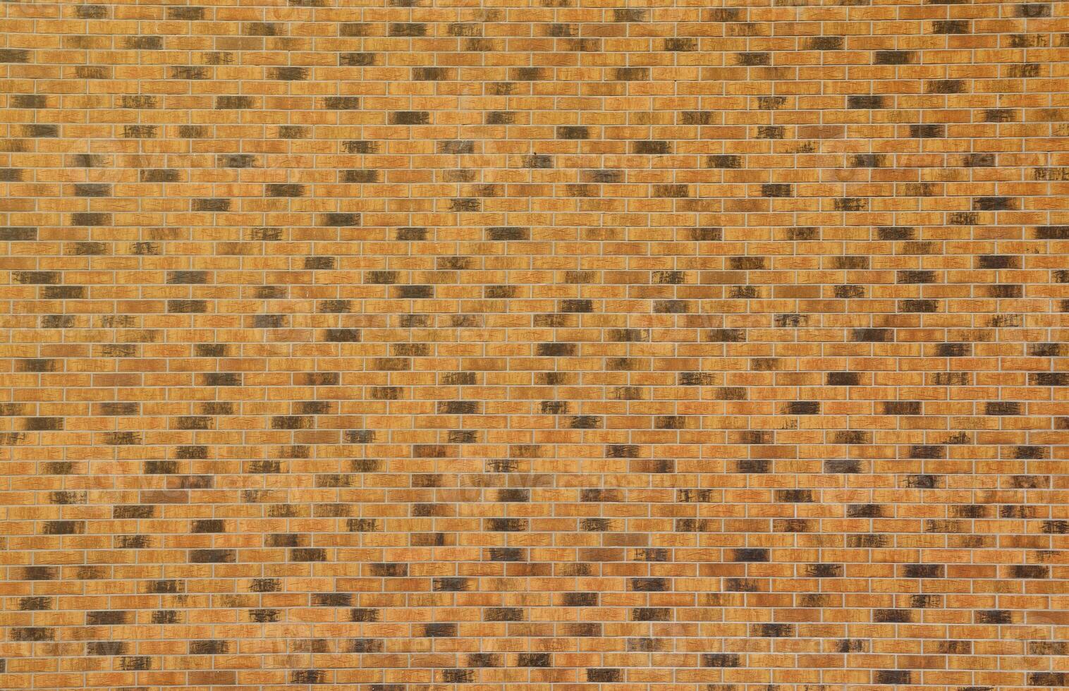 Dark brick wall pattern with chaotic masonry order. Background texture or resource for 3d texturing. Many bricks in big modern stone wall photo