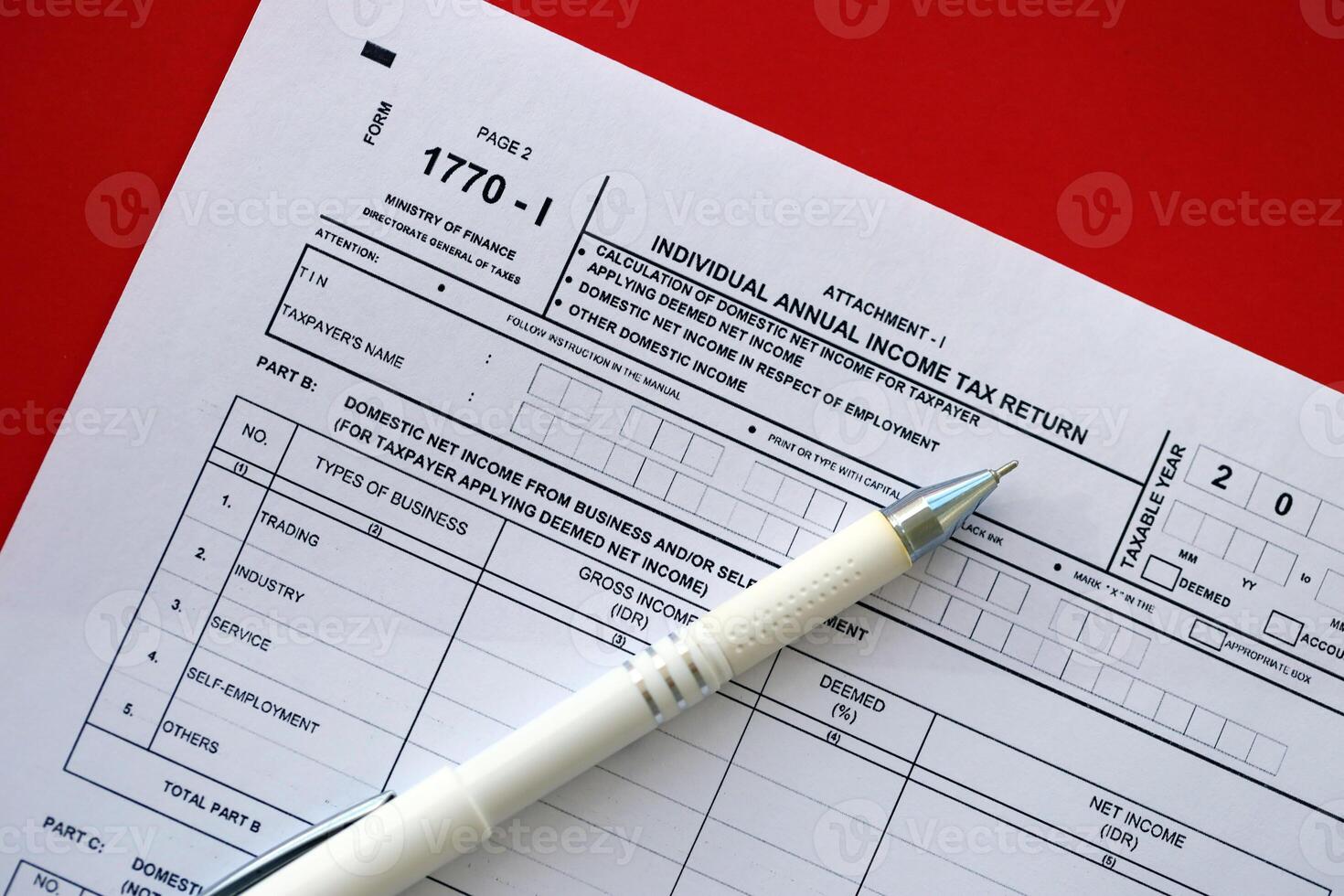 Indonesian tax form 1770-1 Individual Income Tax Return and pen on table photo