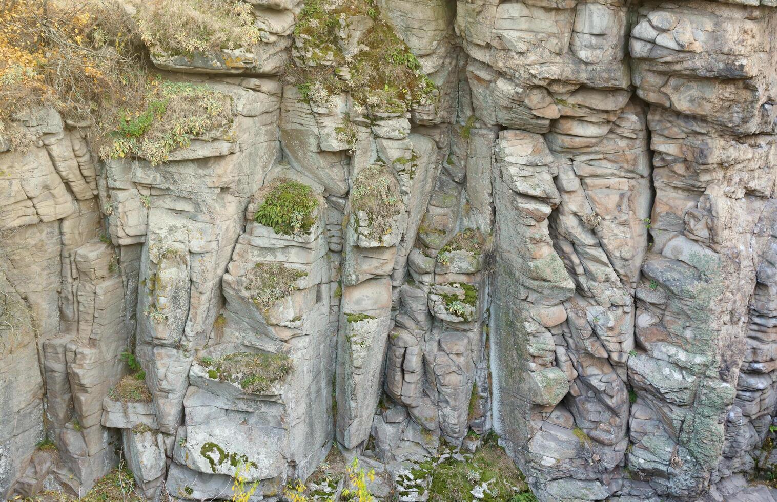 Light coarse natural rock stone background. Mining cliff rough front surface. Big limestone stack backdrop. Heavy grunge damaged granite block texture photo
