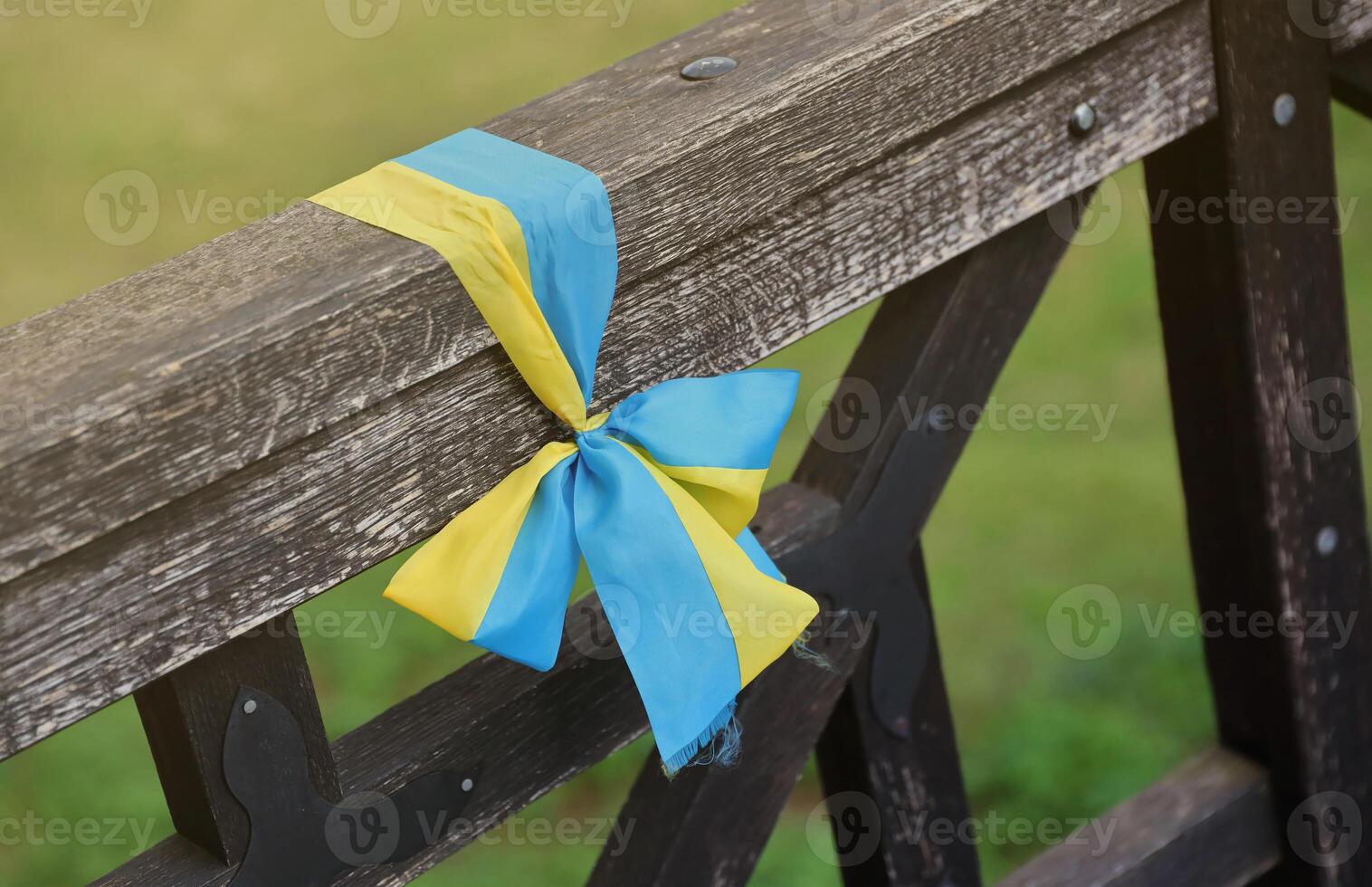 Ribbons in the colors of the national flag of Ukraine are tied to the handrail photo