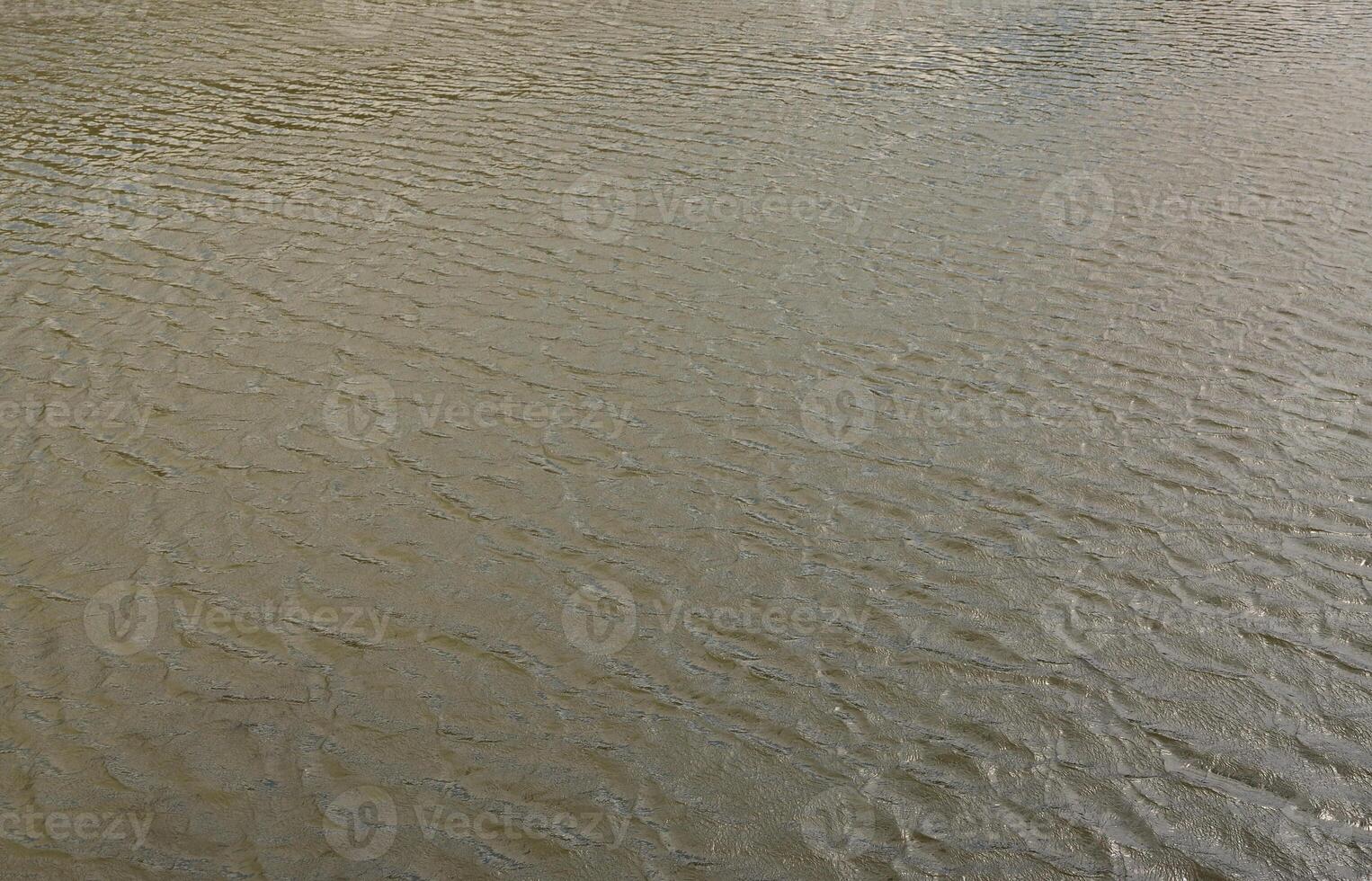 The texture of dark river water under the influence of wind, imprinted in perspective. Horizontal image photo