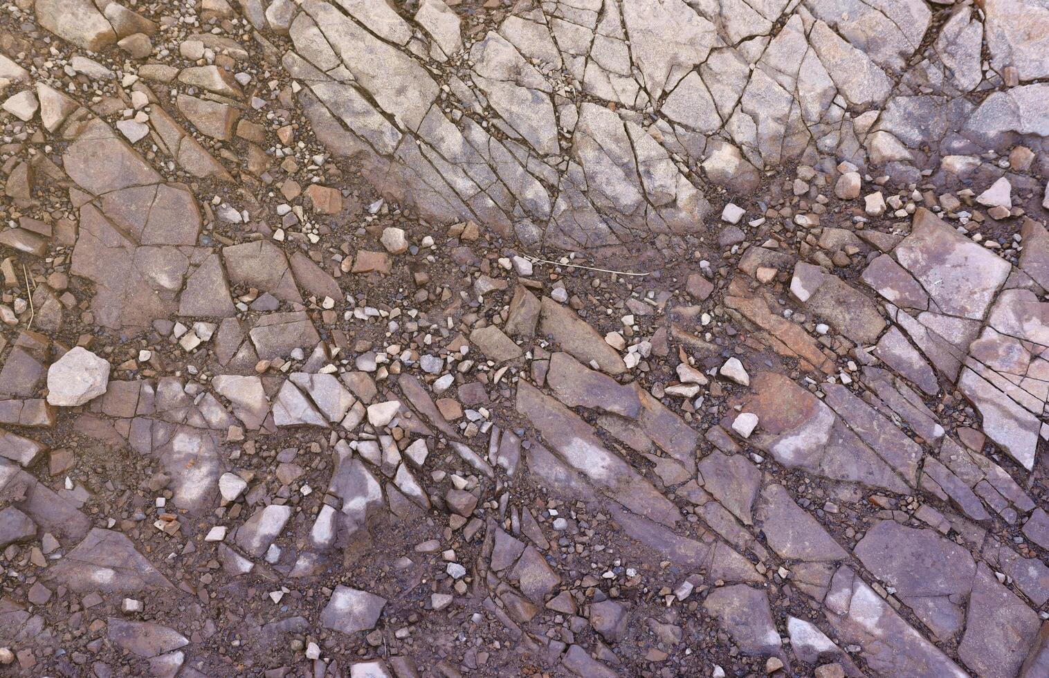 Background of shattered stony stones surface in mountain area. Texture with natural light photo
