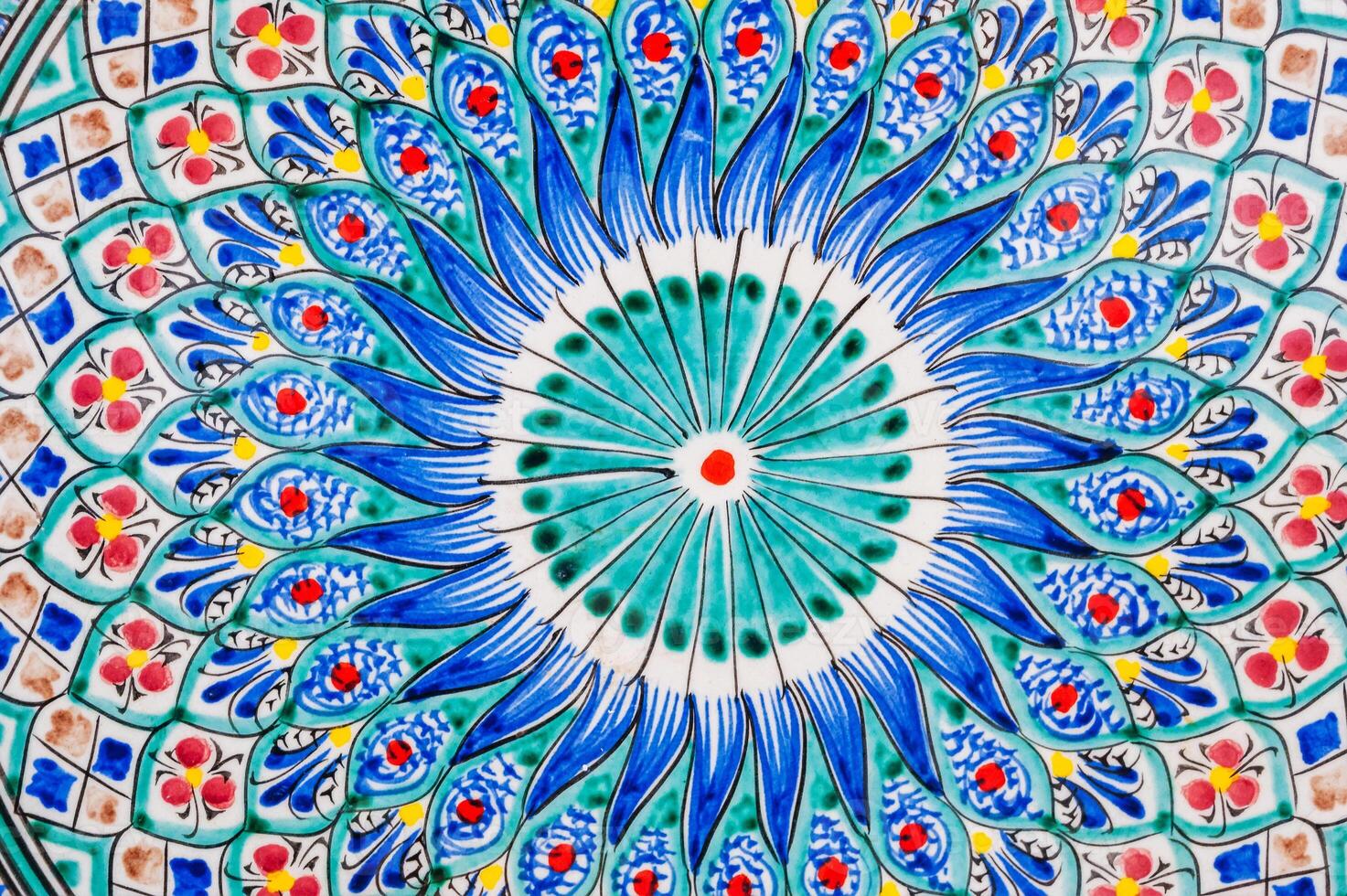 colorful pattern on Uzbek ceramic plates hand-painted close up in oriental style photo