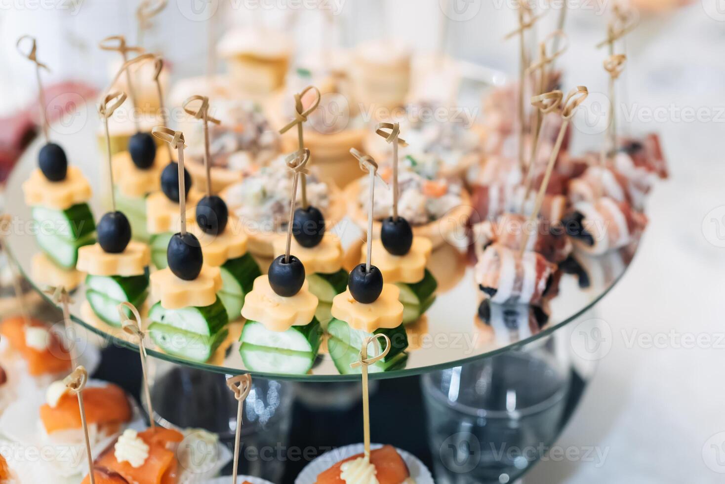 canapes with olives, cheese, cucumber and red fish for a delicious appetizer photo
