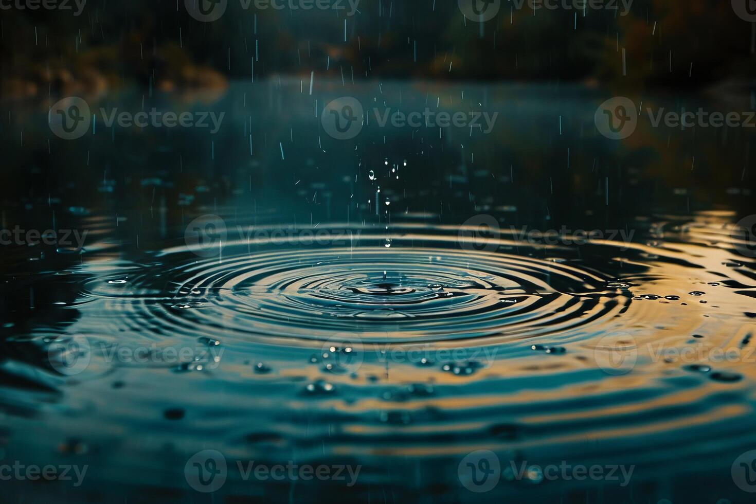 Gentle raindrops falling onto a calm body of water, creating ripples on the surface photo