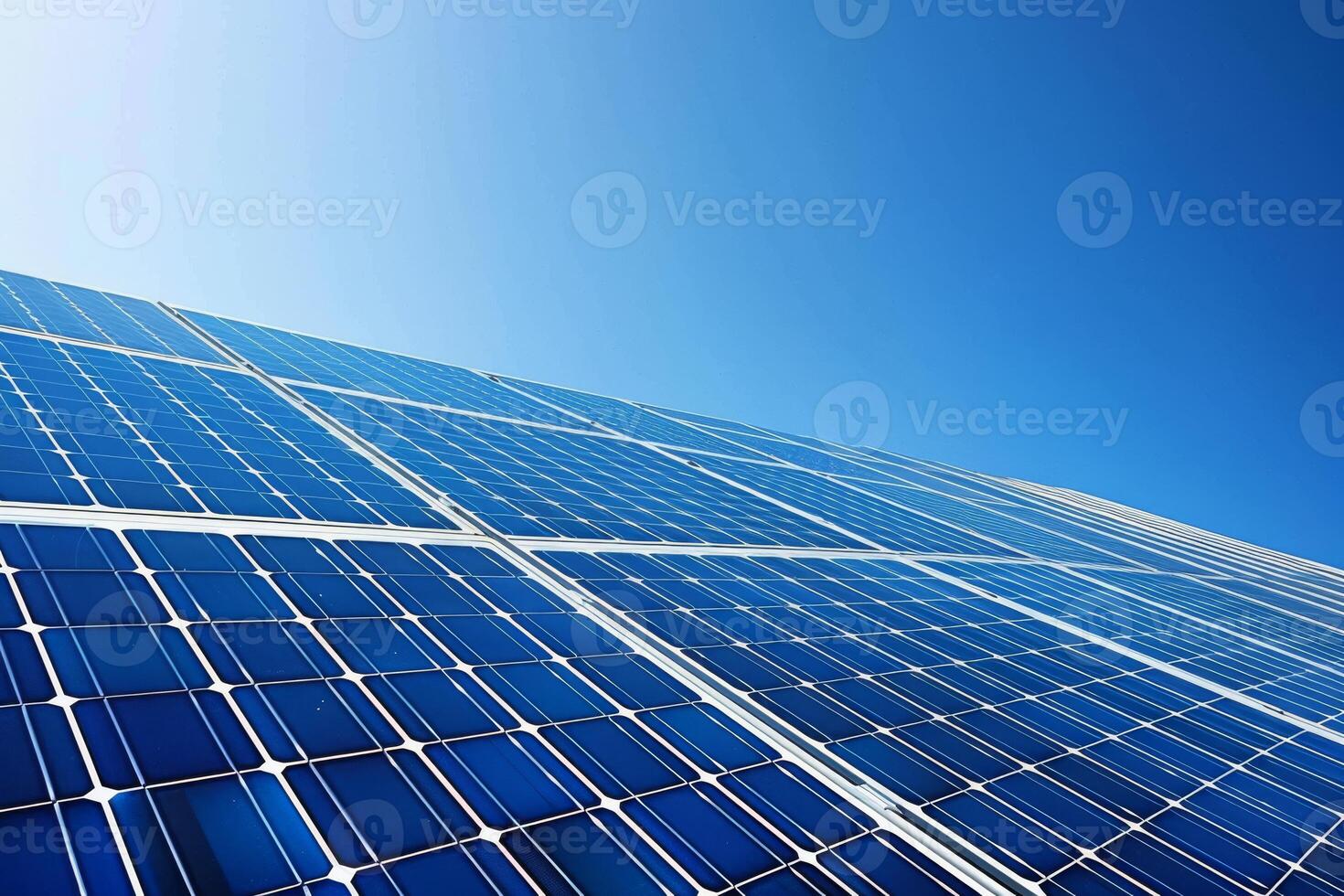 Solar panels against a clear blue sky, harnessing renewable energy for a greener future photo