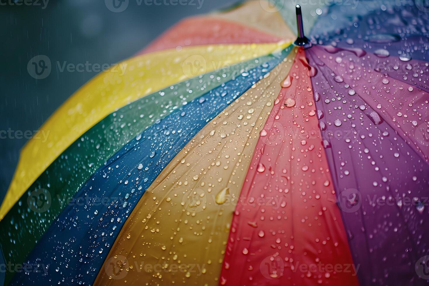 Rainbow-colored umbrella transparently shielding against raindrops on a cloudy day photo