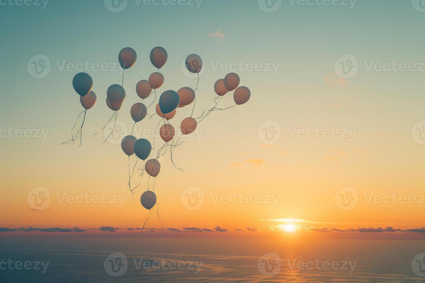 Bunch of balloons released into the sky at sunset, creating a magical and unforgettable moment photo