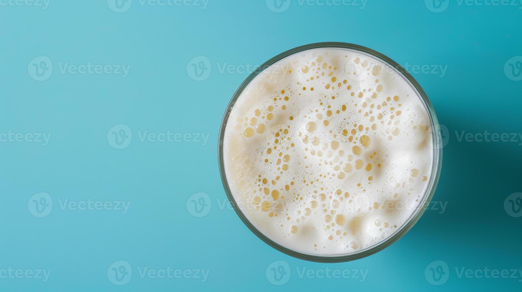 Top-down shot of a spinning glass of milkshake with room for text photo