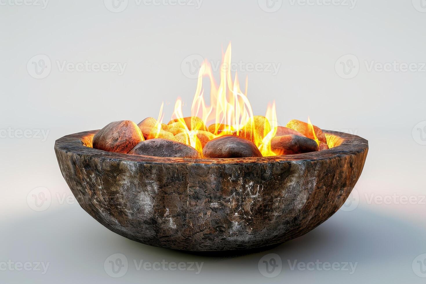 A fire pit with a large bowl of rocks in it. The fire is burning brightly and the rocks are glowing red photo