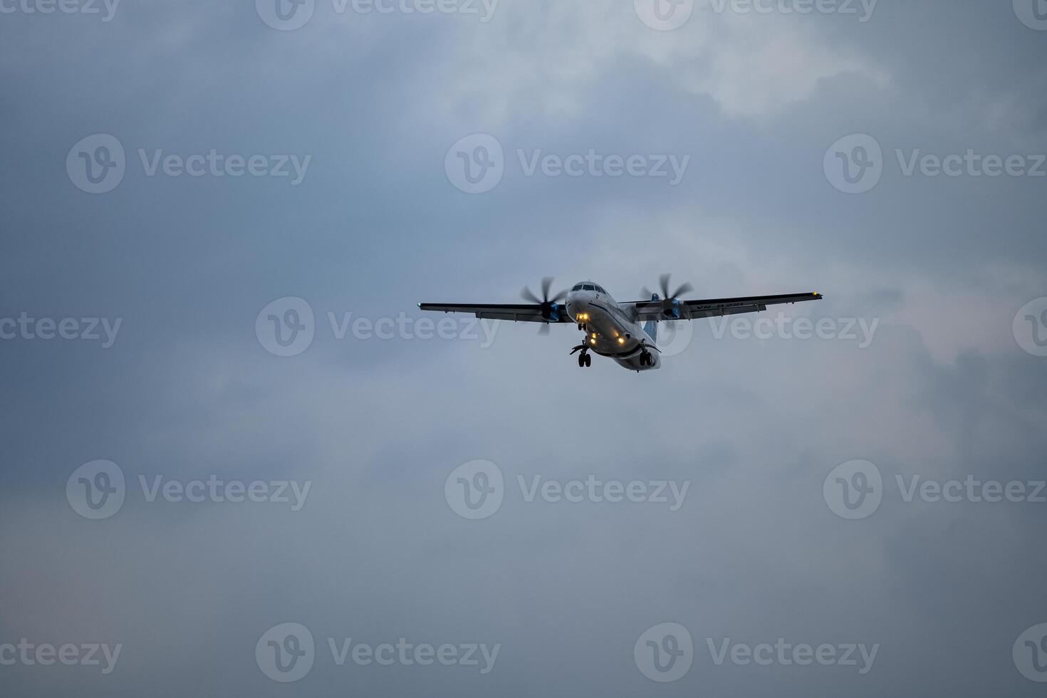 Airplane registration flying on cloudy day, approaching landing in Tan Son Nhat Airport in Vietnam photo