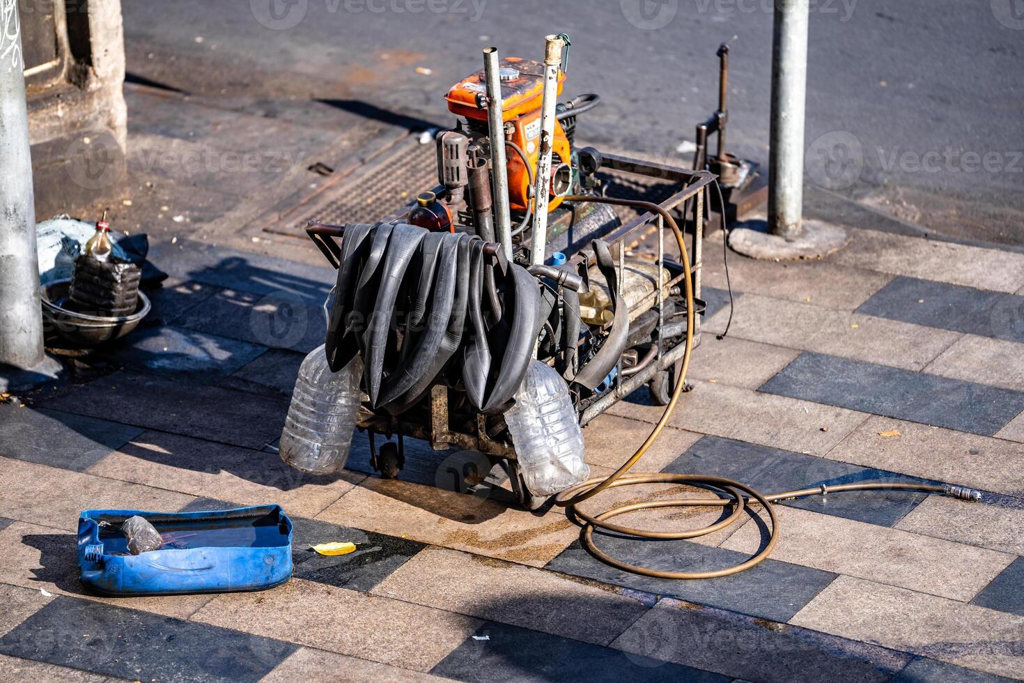 Man repairing motorbike on the street in Ho Chi Minh City, Vietnam photo