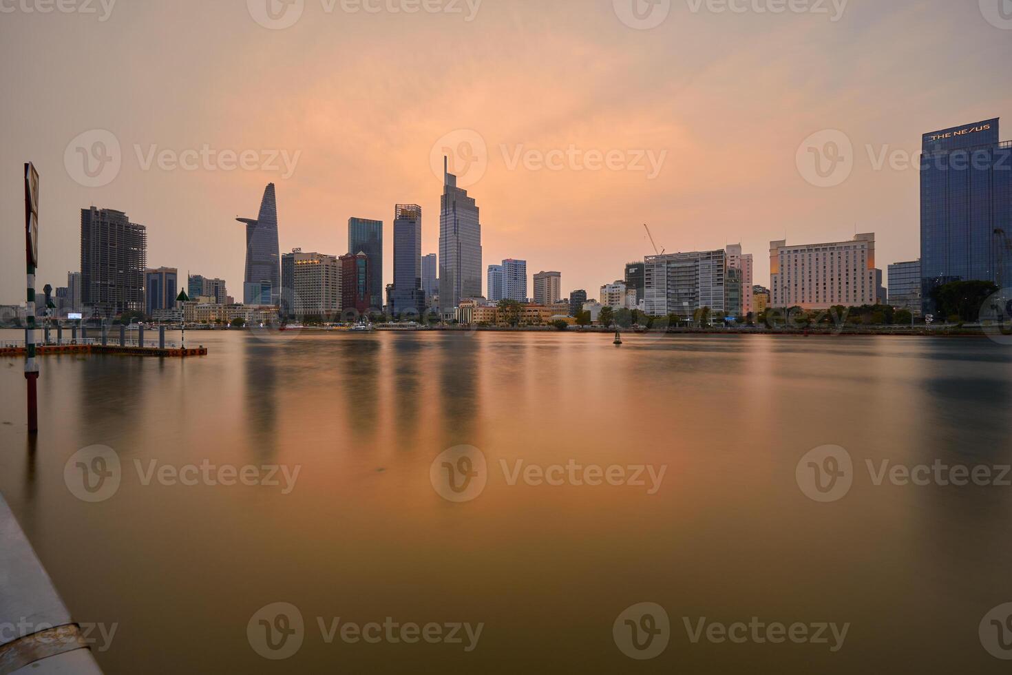 Ho Chi Minh City skyline and the Saigon River. Amazing colorful night view of skyscraper and other modern buildings at downtown. Travel concept photo